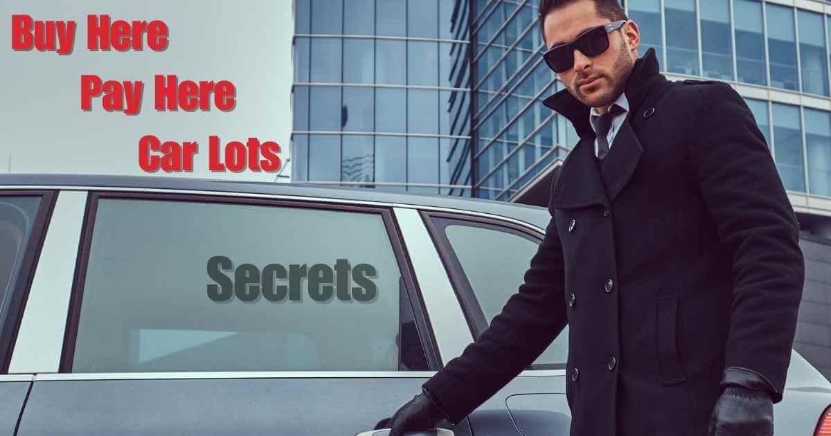 a mysterious man opening up a car door that is heavily tinted and the words "buy here pay here car lots" above the door and "secrets" inside the window.