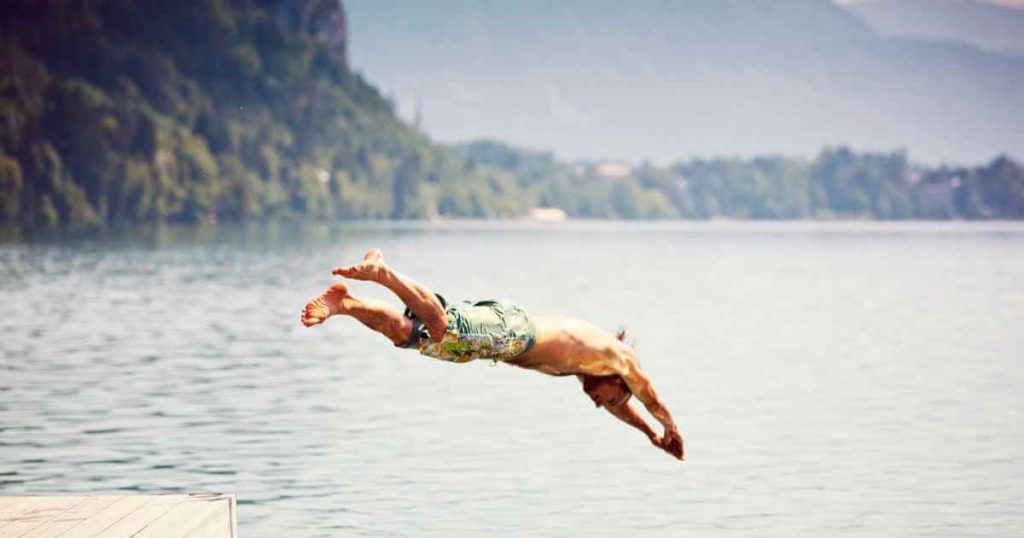 a man diving headfirst into the ocean of do you need credit to buy a car