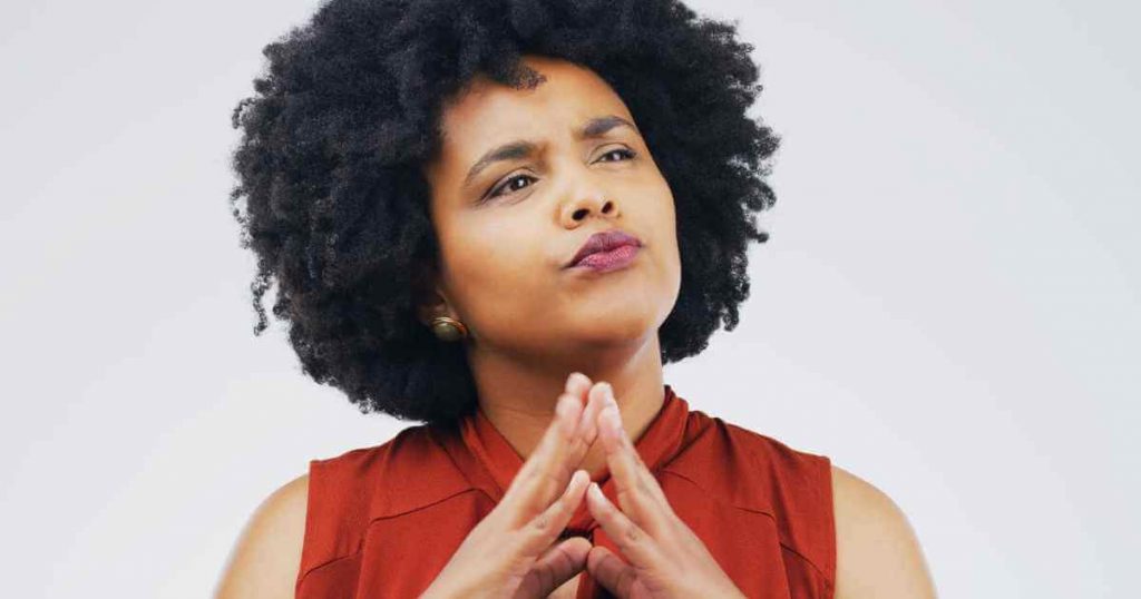 a woman with her fingers steepled as she attempts to understand in house financing