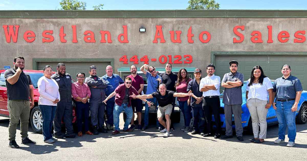 a picture of Westland Auto Sales staff inviting you to join them in front of their office and welcoming you into their buy here pay here near me program