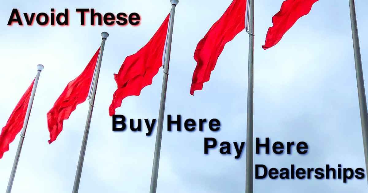 red flags waving in the air with the words "avoid these buy here pay here dealerships"