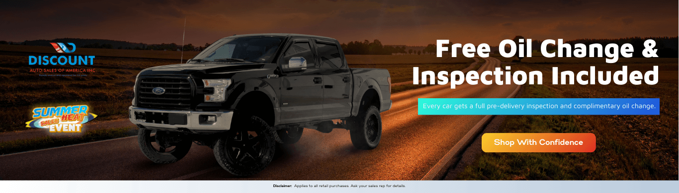 This banner features a rugged black Ford pickup against a warm sunset backdrop, highlighting Discount Auto Sales of America’s complimentary oil change and pre-delivery inspection offer. It emphasizes buyer confidence with a bold “Shop With Confidence” call-to-action and Summer Sales Heat Event branding.