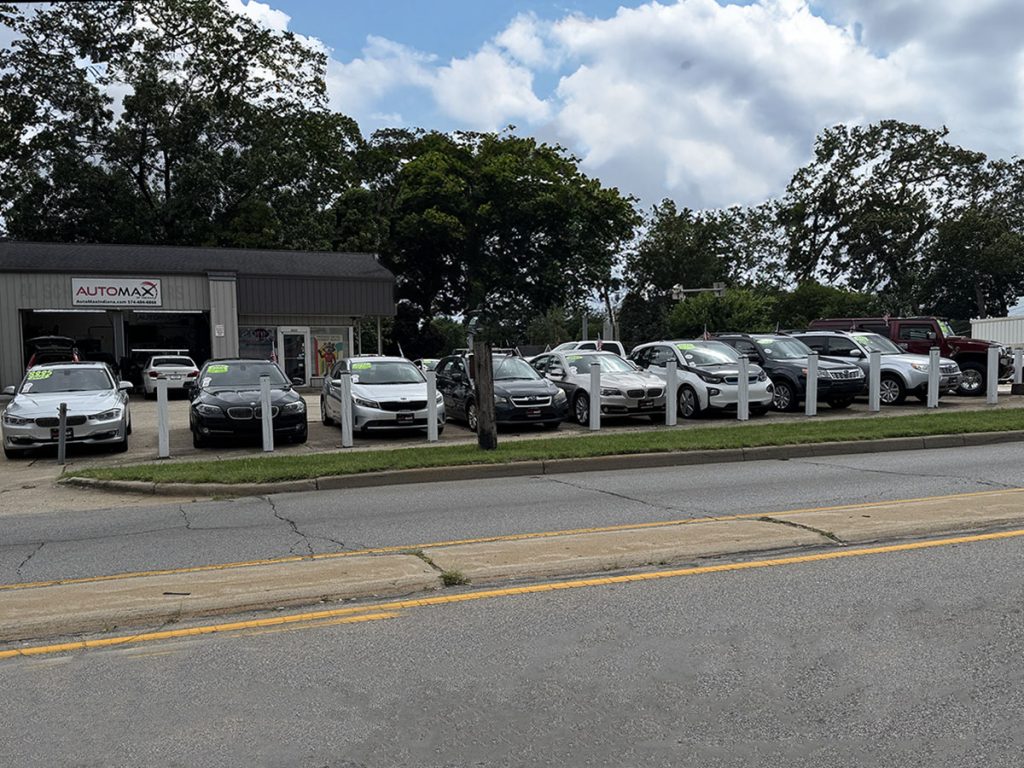 Automax Indiana dealership lot in Mishawaka with used cars lined up for sale.