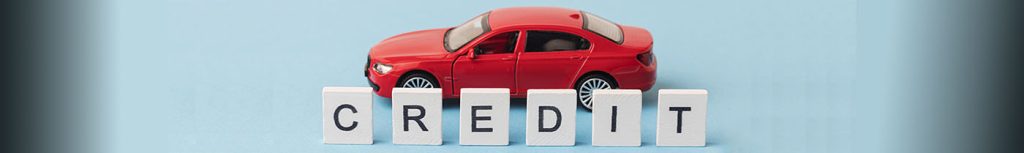 Red car with blocks spelling “CREDIT” — auto financing for all credit in Mishawaka