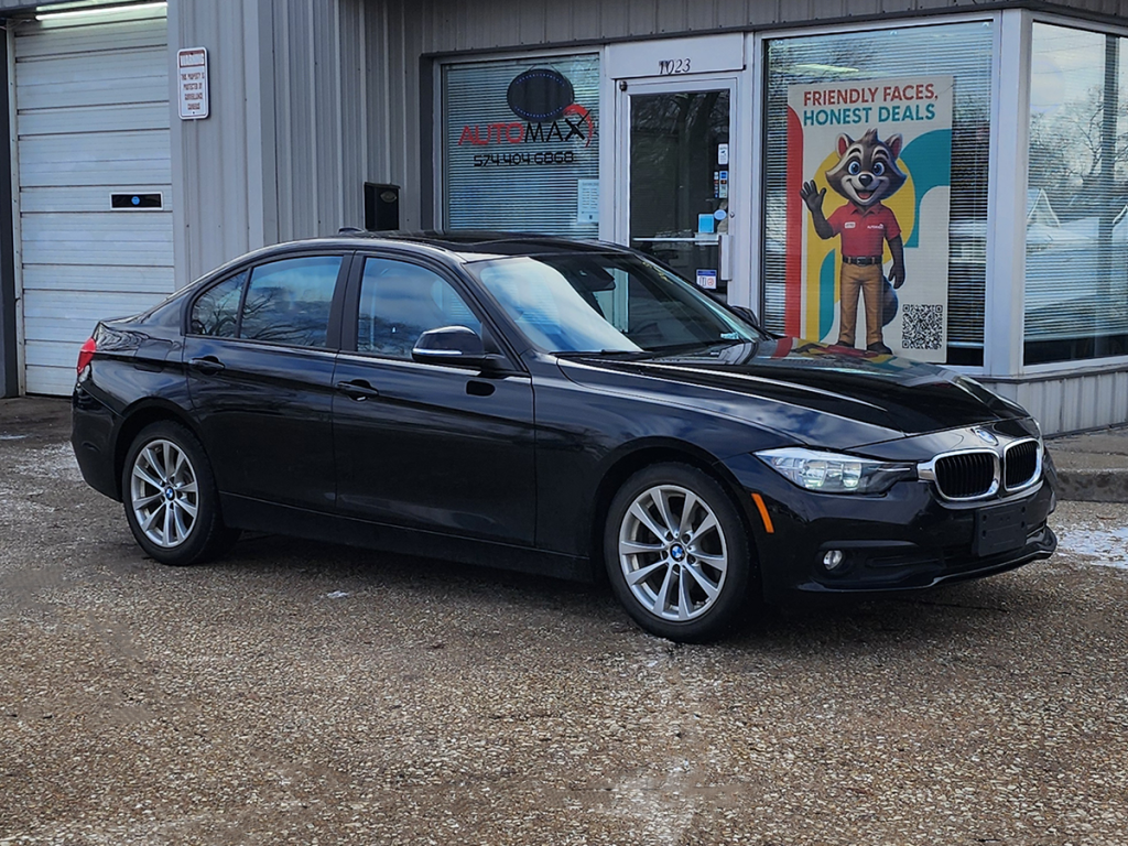 2016 BMW 320i sedan parked in front of Automax of Indiana dealership in Mishawaka, Indiana.