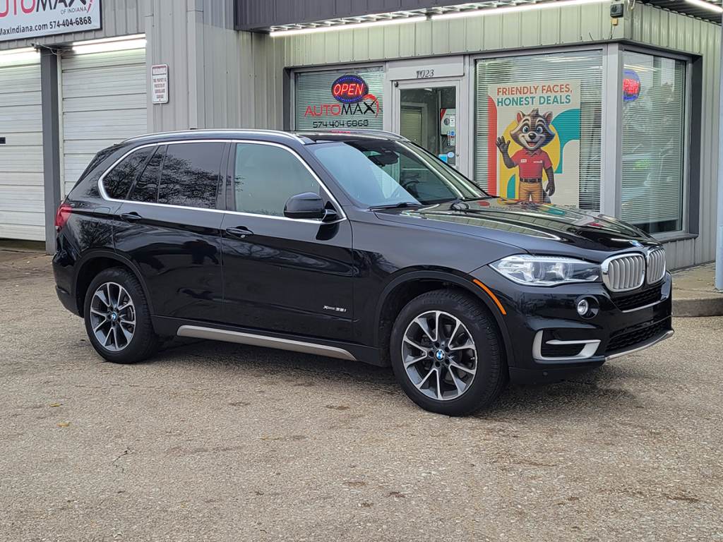 2018 BMW X5 SUV parked in front of Automax of Indiana dealership in Mishawaka, Indiana.