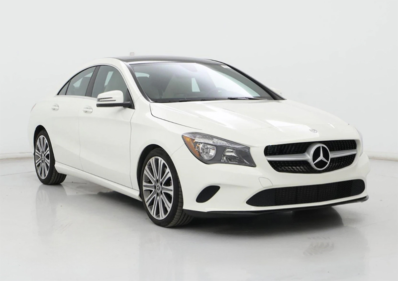 White used Mercedes-Benz sedan photographed in a studio, front three-quarter view, available in Mishawaka Indiana