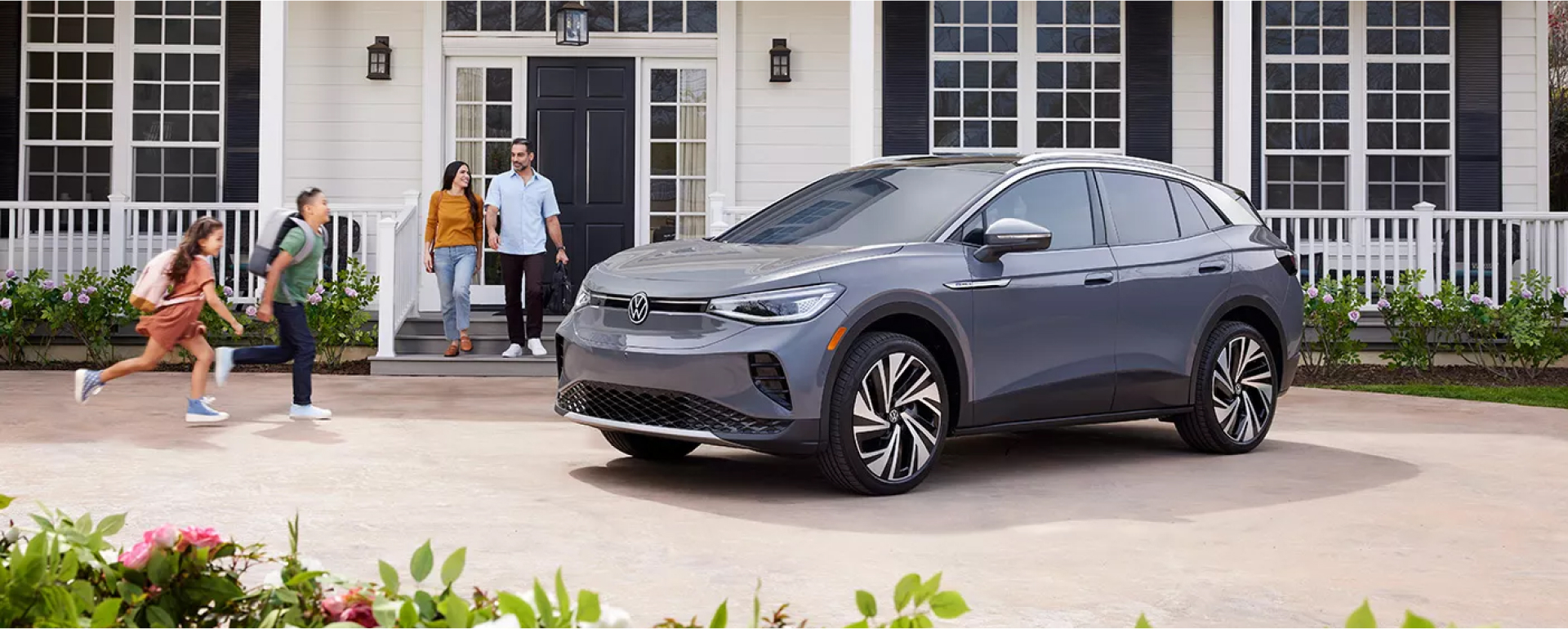 Family getting into their new gray SUV