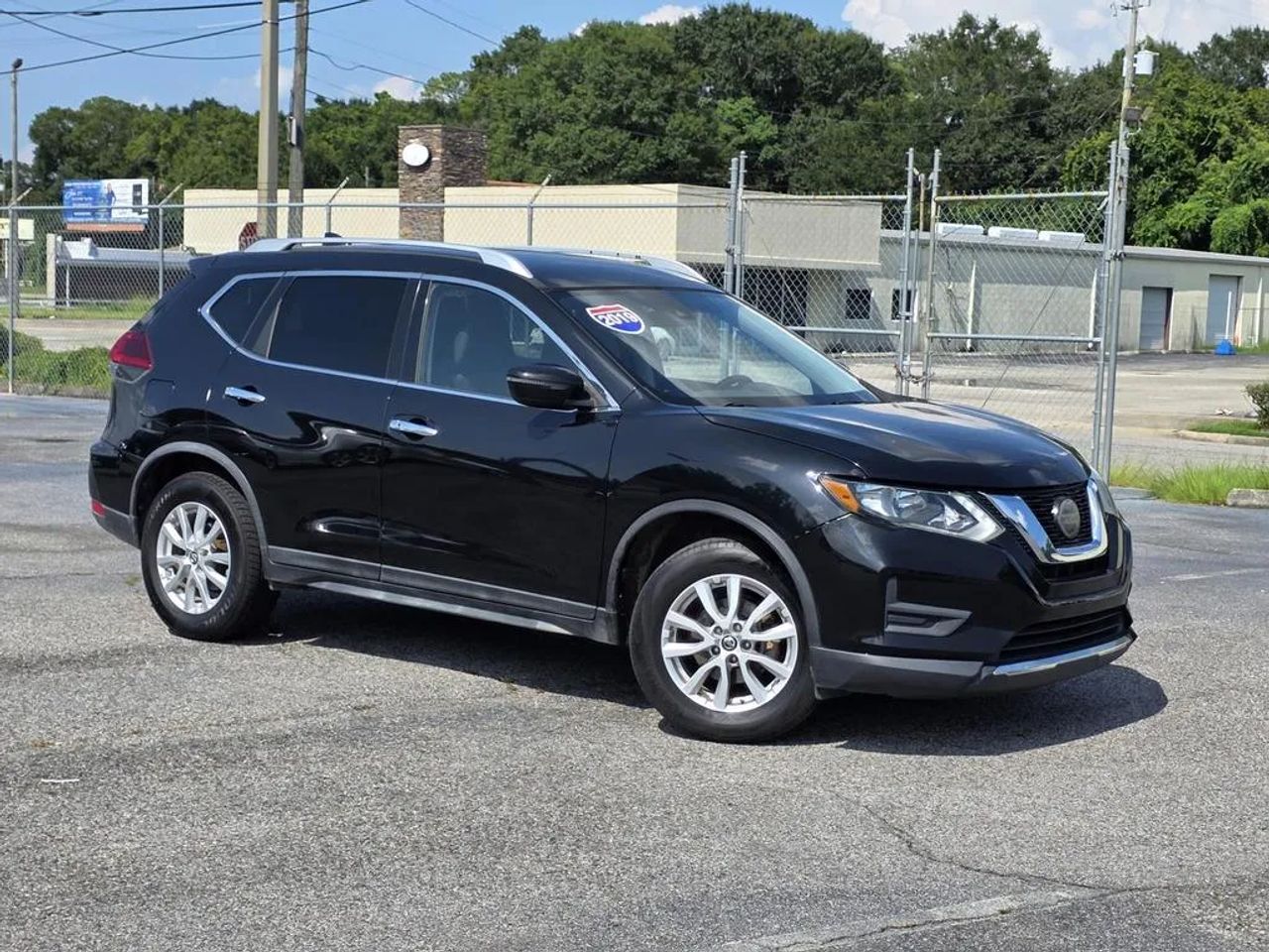 2019 Nissan Rogue SV driving near Mobile Alabama showcasing sleek SUV design
