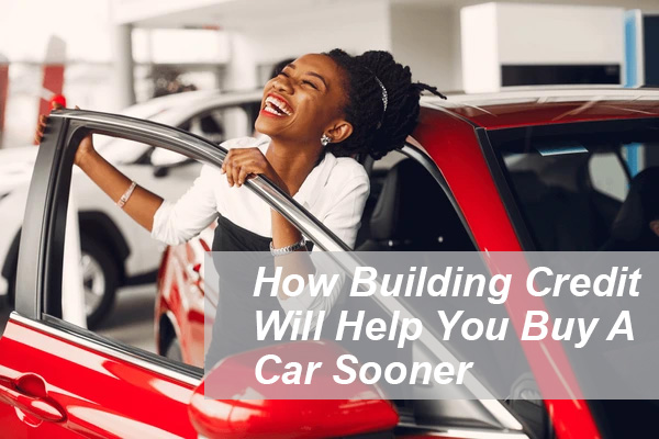 Happy woman celebrating after buying a new red car, representing how building credit can help you qualify for an auto loan sooner.
